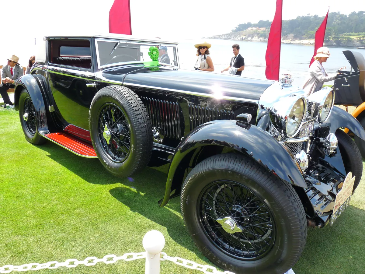 A prewar touring car with a deep black coachwork finish